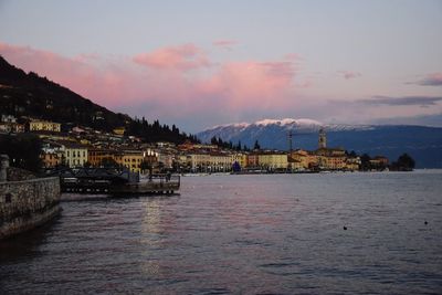 Scenic view of river by mountains against sky