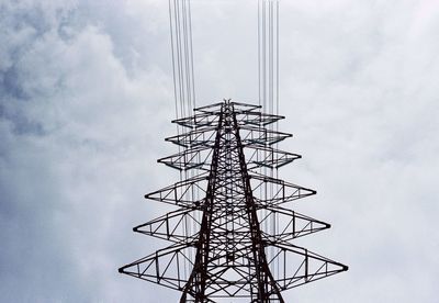 Low angle view of electricity pylon against sky