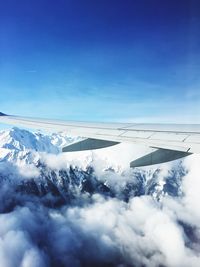 Scenic view of snow mountains against blue sky