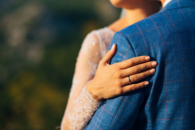 Midsection of woman standing against blurred background