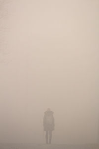 Person standing in fog