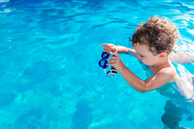 Boy swimming in pool