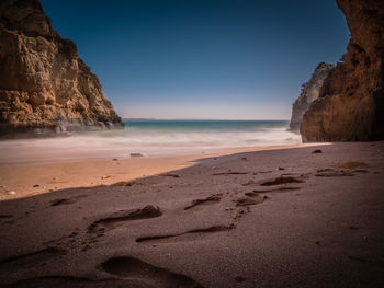 Scenic view of beach against clear sky