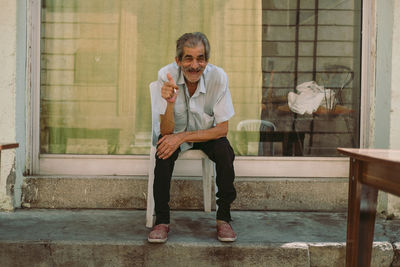 Portrait of a smiling young man sitting on seat