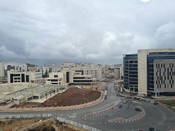 High angle view of road by buildings against sky