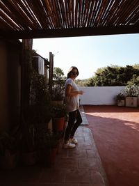 Full length of woman standing against sky