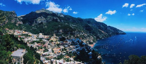 Scenic view of mountains and sea against blue sky