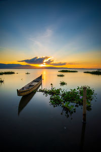 Scenic view of lake against sky during sunset