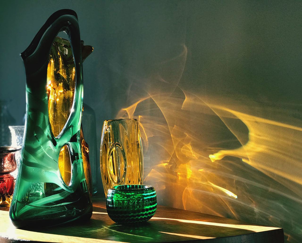 CLOSE-UP OF BURNING CANDLES ON TABLE