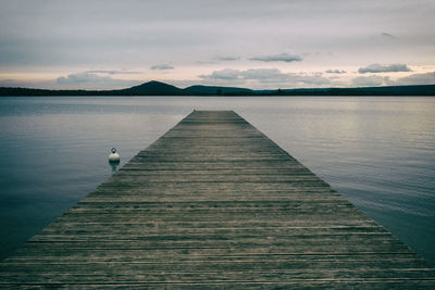 Wooden pier on a quiet and peaceful large lake in france