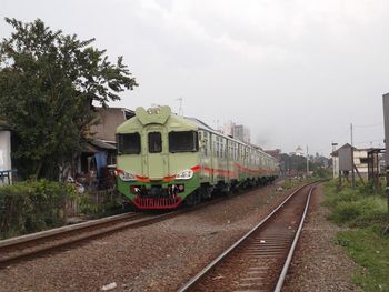 Train at railroad station against sky