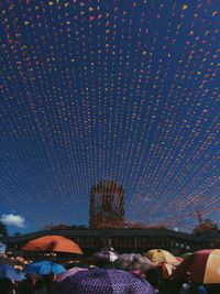 Low angle view of illuminated ferris wheel at night