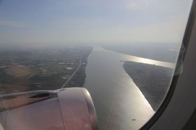 Aerial view of cityscape seen through airplane window