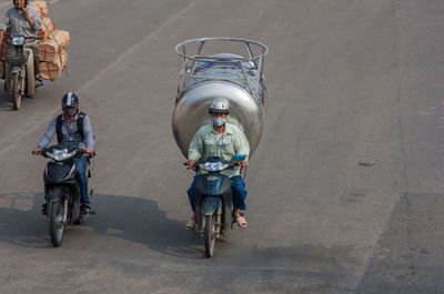 People riding bicycle on road