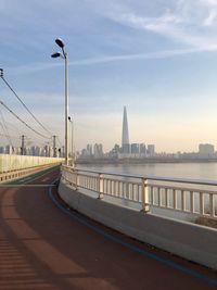 View of bridge over city against sky