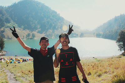 Portrait of smiling friends standing on land