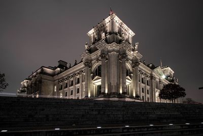 Low angle view of illuminated building against sky