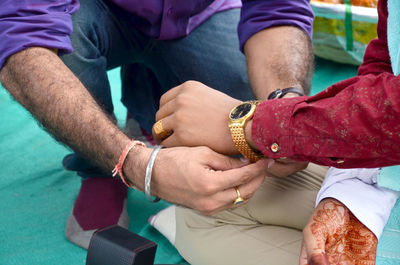 Midsection of couple holding hands