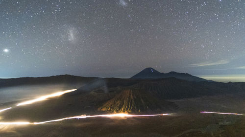 Scenic view of illuminated mountains against sky at night