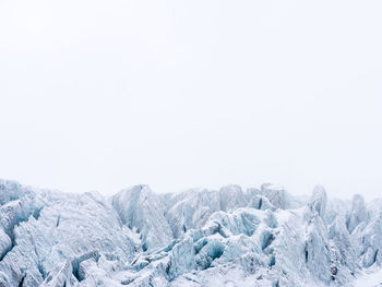 Scenic view of snow covered mountain against clear sky