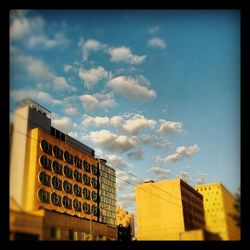 Low angle view of building against cloudy sky