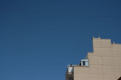 Low angle view of building against clear blue sky