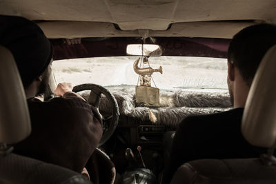 Rear view of man traveling in car