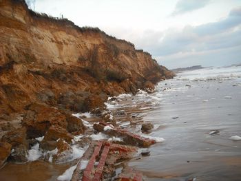 Scenic view of sea and mountains against sky