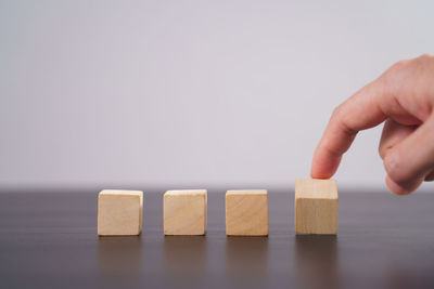 Close-up of hand with toy on table