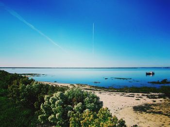 Scenic view of sea against clear blue sky