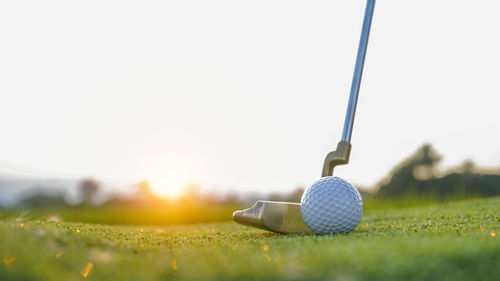 Low section of person playing golf on field