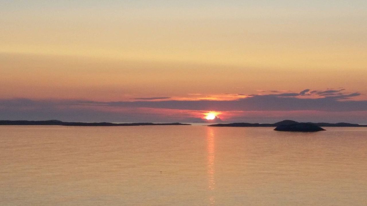 VIEW OF SEA AGAINST SUNSET SKY