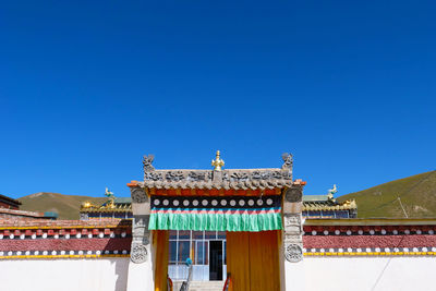 Low angle view of traditional building against clear blue sky