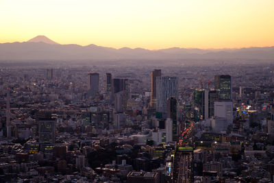 Aerial view of city buildings during sunset