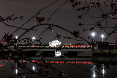 View of illuminated bridge against sky at night