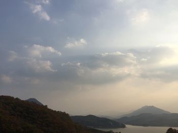 Scenic view of mountains against cloudy sky