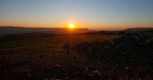 Scenic view of landscape against sky during sunset