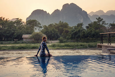 Full length of man standing on lake against sky