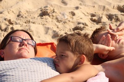 Son with mother relaxing at beach