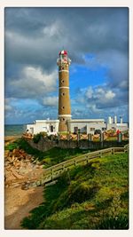 Lighthouse against cloudy sky