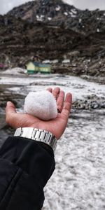 Close-up of person hand holding snow