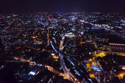 Illuminated cityscape against sky at night