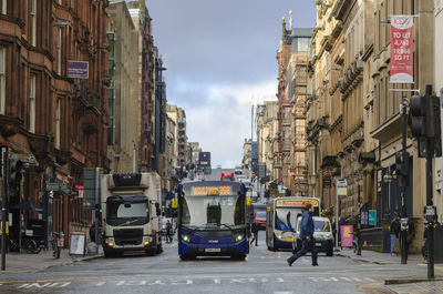 Side view of man crossing road in city