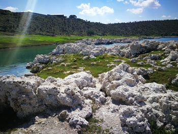 Scenic view of waterfall against sky