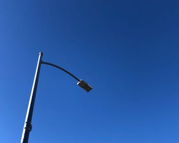 Low angle view of street light against clear blue sky