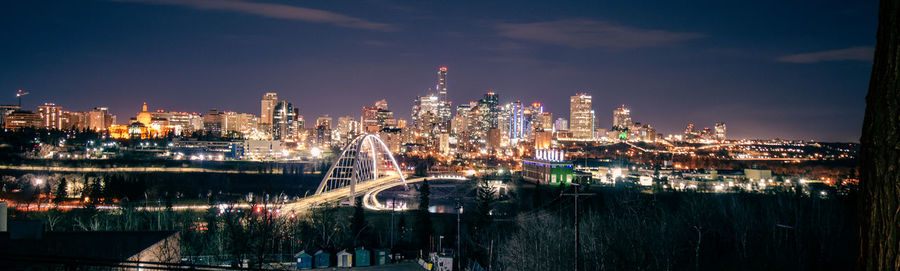 Illuminated buildings against sky at night