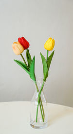 Close-up of artificial tulip flowers in vase on table