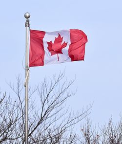 Low angle view of flag on pole against sky