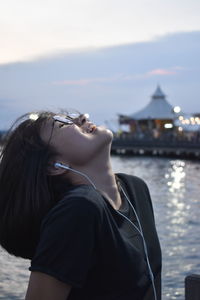 Midsection of woman against sea against sky