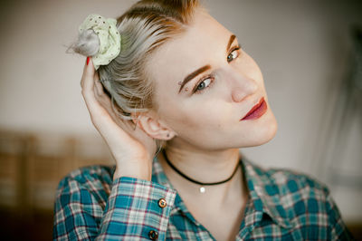 Close-up of portrait of young woman at home